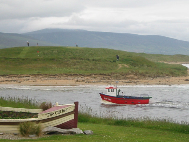 Cathie looks on as boat enters Brora Harbour Photo | UK Beach Guide